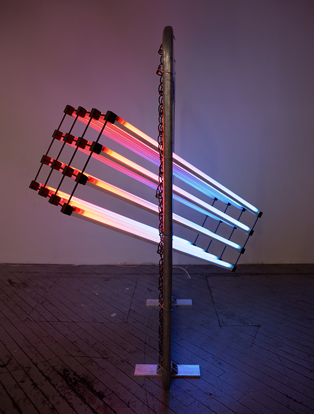 Thermal Energy (2013) 160cm x 120cm x 90cm An array of lights intersect through a fence at an angle, with the colors visualizing hot air rising and cold air sinking. This work visualizes what is invisible, air, and shows it passing through a fence, letting the viewer think about air as a substance that fills all open spaces and travels through fences, borders, etc.